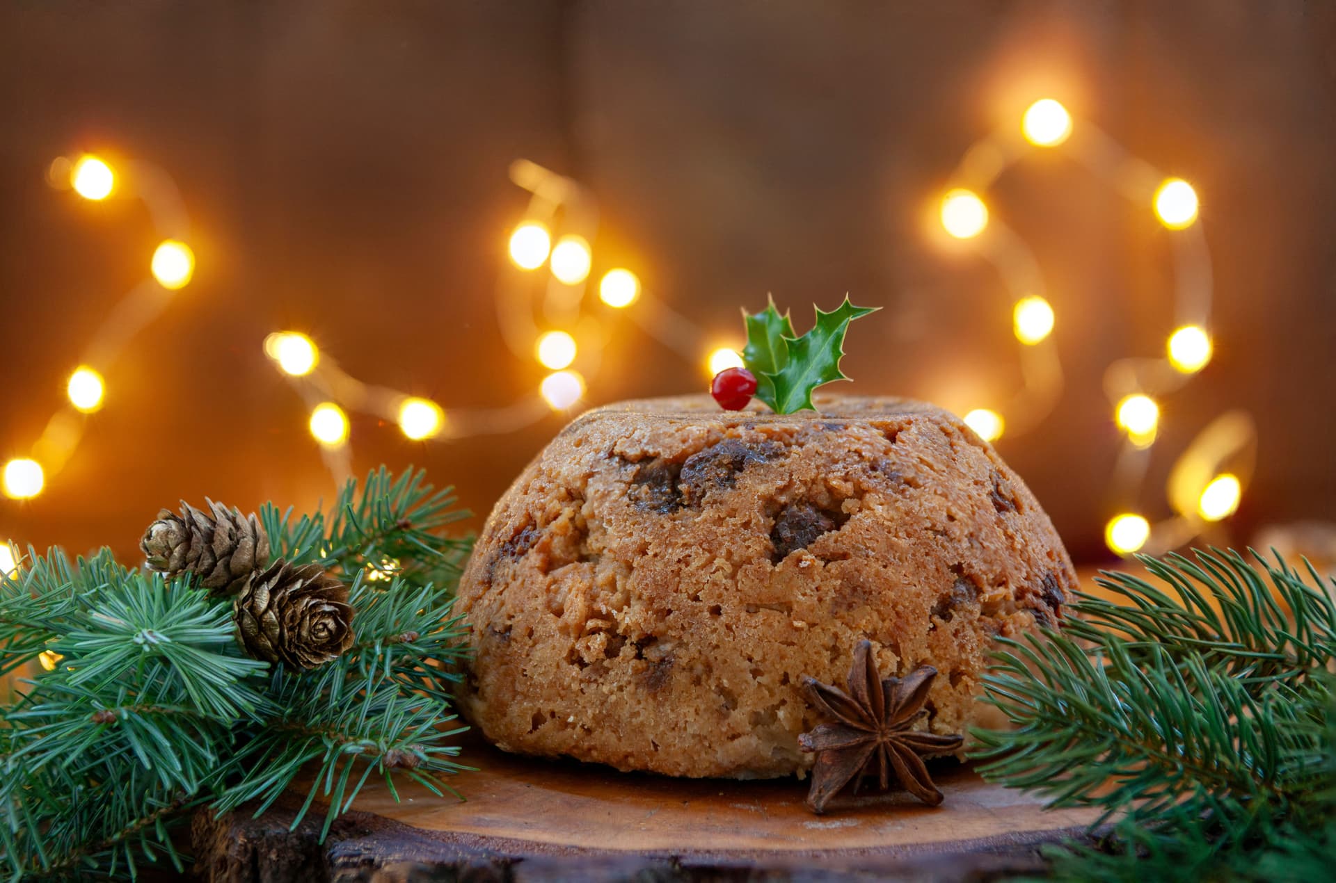 Traditional Christmas figgy pudding with holly garnish