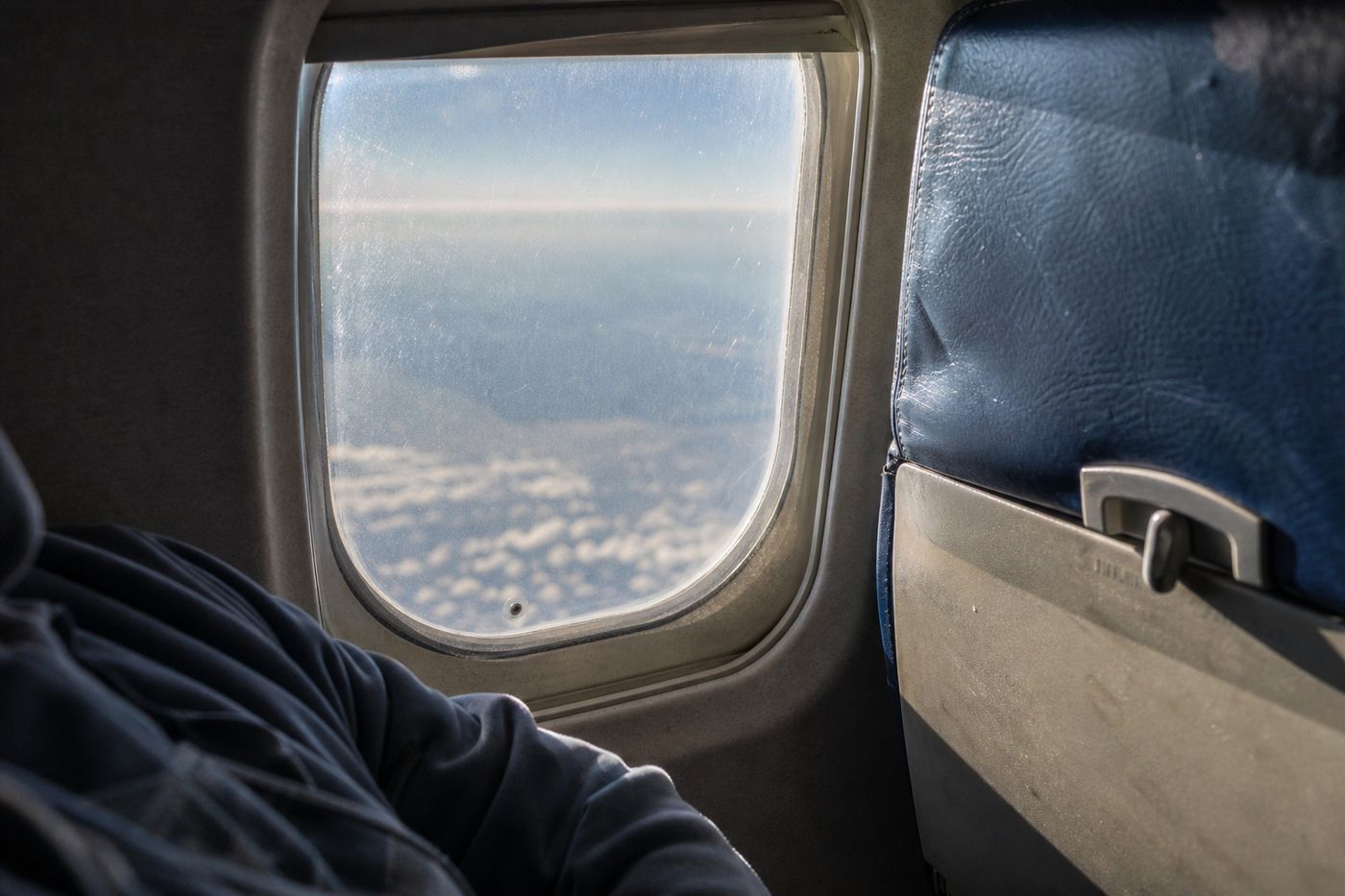 Airplane window with tiny hole