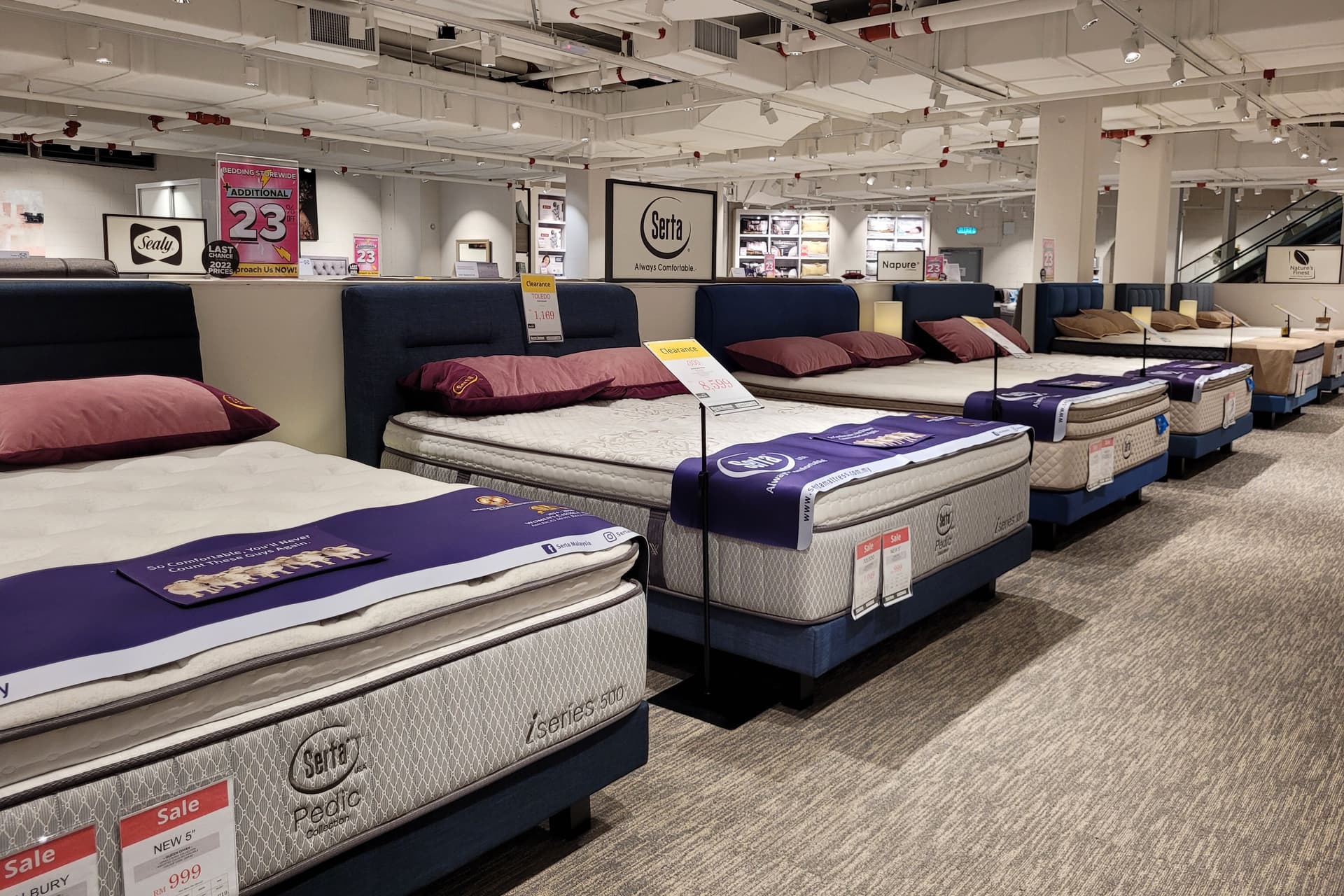 Mattress store showroom with sale signs